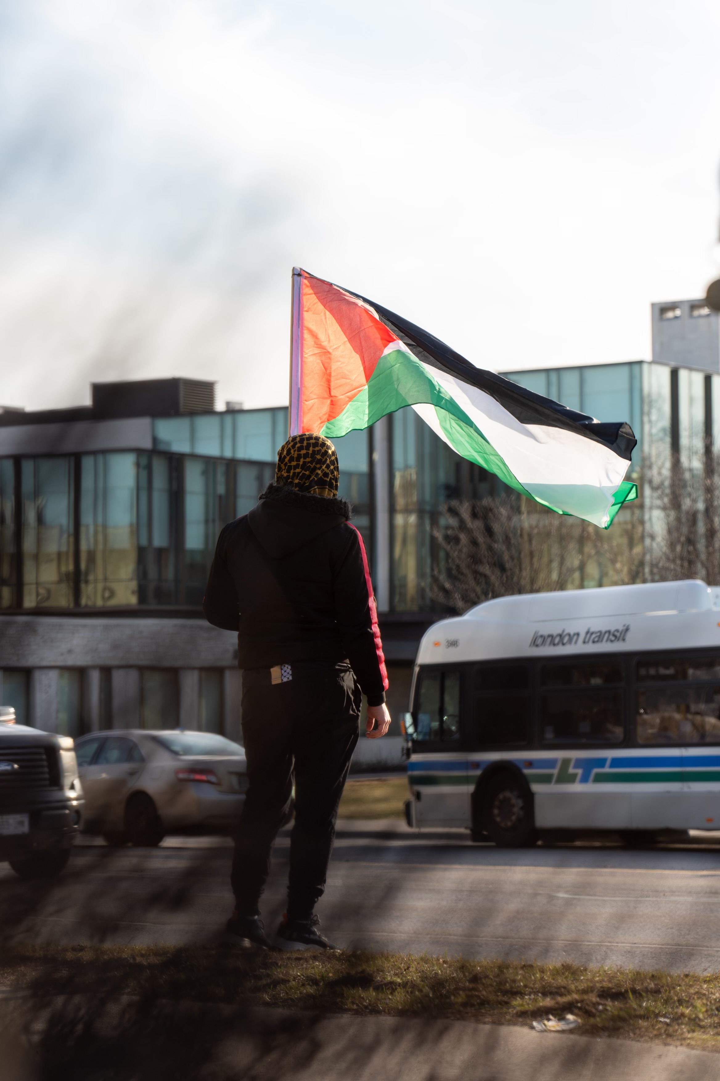 A protestor with a Palestinian flag. Photo taken by Moses Odida.